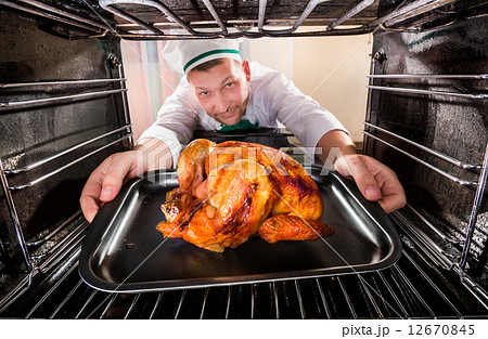 Cooking chicken in the oven. 12670845