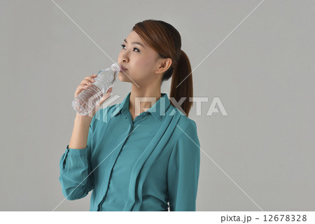 Asian Lady drinking bottle water Asian Lady drinking bottle water 12678328