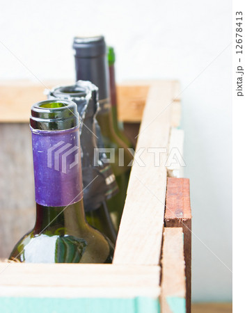 Empty vine bottles in wooden crate. 12678413