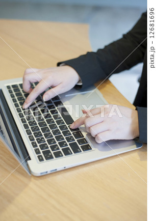 An executive typing a report on a laptop. 12681696
