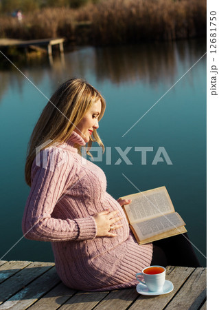 Pregnant woman on the autumn lake 12681750