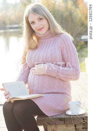 Pregnant woman on the autumn lake 12681764