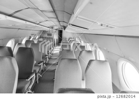 Interior of an airplane with many seats 12682014