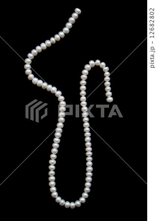 White pearls on a black velvet 12682802