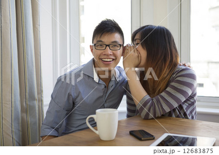 Two happy Chinese friends sharing secrets. Two happy Chinese friends sharing secrets. 12683875