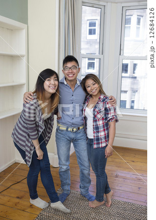 Portrait of three Asian friends relaxing at home. Portrait of three Asian friends relaxing at home. 12684126