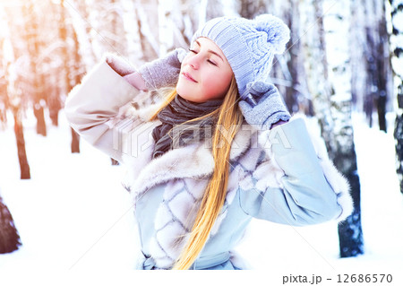 Young beautiful girl posing in winter park on a sunny day 12686570