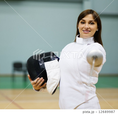 Young woman fencer with epee 12689987