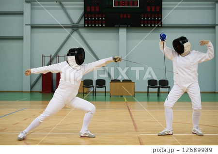 Two women fencers on a training 12689989