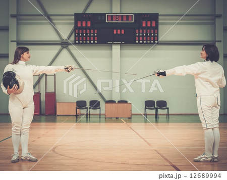 Young woman fencer and her trainer Young woman fencer and her trainer 12689994
