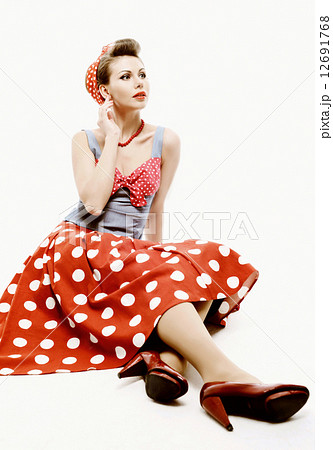 Pinup young woman isolated on white studio background 12691768