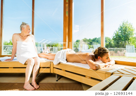 Senior and young woman in sauna sweating in heat 12693144
