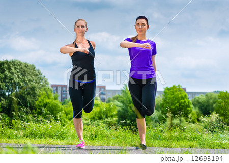 Sports outdoor - young women doing fitness in park 12693194