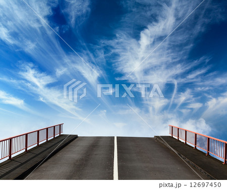 Asphalt road going into sky with clouds 12697450