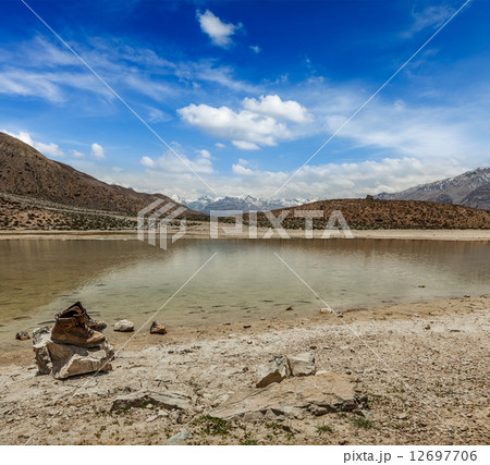 Trekking hiking boots at mountain lake in Himalayas 12697706