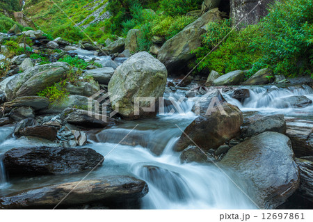 Cascade falls over mossy rocks 12697861