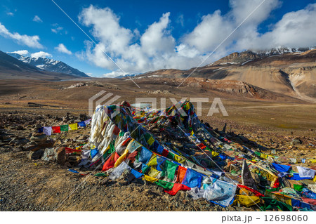 Buddhist prayer flags (lungta) on Baralacha La pass in Himalayas 12698060