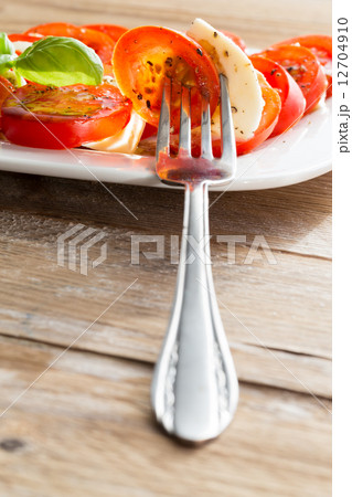 Caprese salad tomato mozzarella with basil 12704910