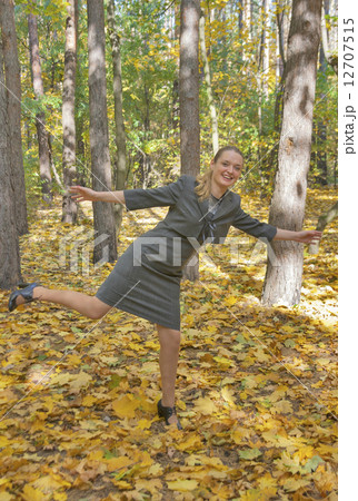 pretty young woman in a gray business dress standing pretty young woman in a gray business dress standing 12707515