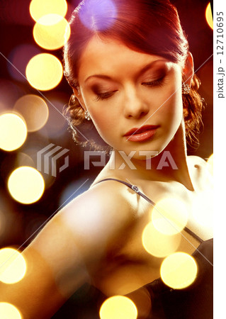woman in evening dress wearing diamond earrings woman in evening dress wearing diamond earrings 12710695