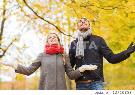smiling couple looking up in autumn park smiling couple looking up in autumn park 12710858