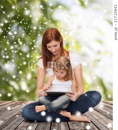 happy mother with little girl and tablet pc happy mother with little girl and tablet pc 12710942