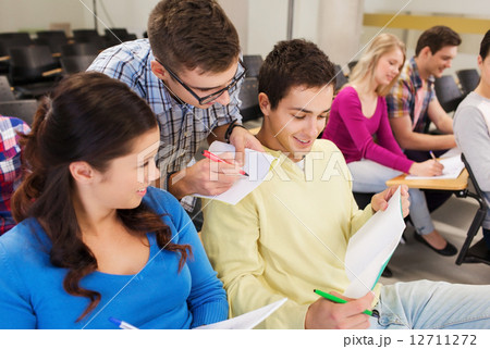 group of smiling students in lecture hall group of smiling students in lecture hall 12711272