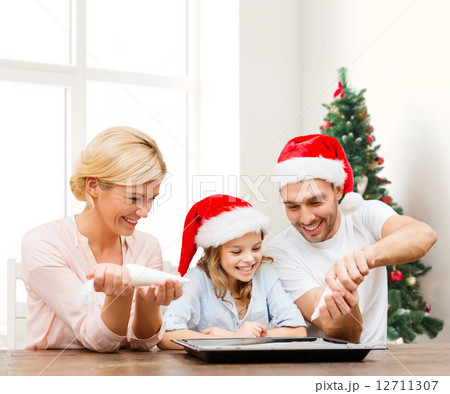 happy family in santa helper hats cooking 12711307