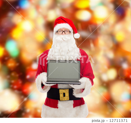man in costume of santa claus with laptop man in costume of santa claus with laptop 12711371