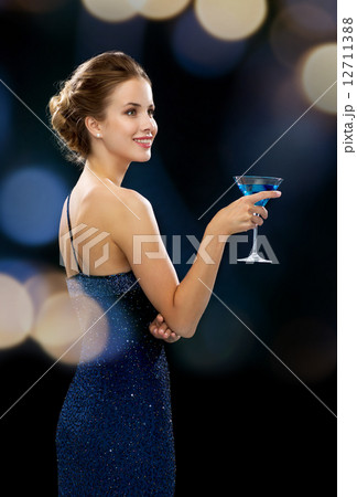 smiling woman holding cocktail 12711388