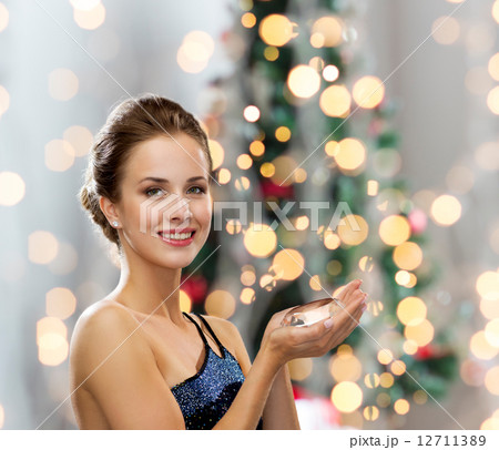 smiling woman in evening dress with diamond 12711389