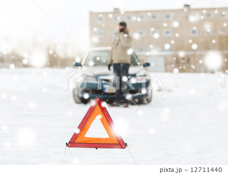 closeup of man with broken car and smartphone closeup of man with broken car and smartphone 12711440