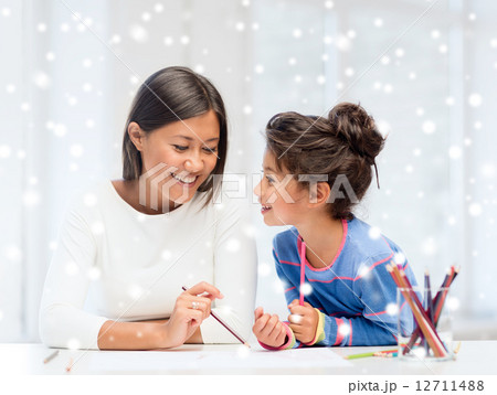 mother and daughter with coloring pencils indoors mother and daughter with coloring pencils indoors 12711488