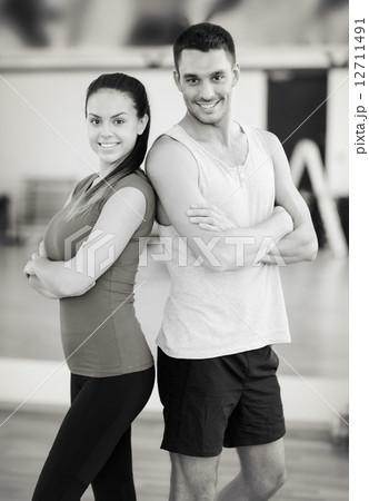 two smiling people in the gym two smiling people in the gym 12711491