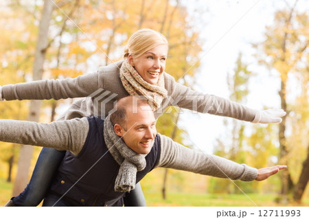 smiling couple having fun in autumn park smiling couple having fun in autumn park 12711993