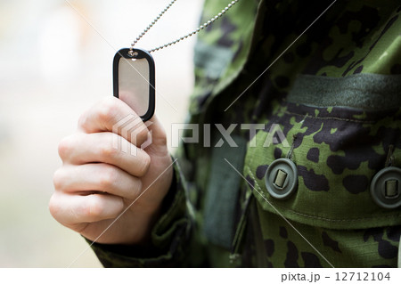 close up of young soldier in military uniform 12712104