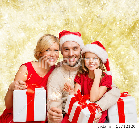 happy family in santa helper hats with gift boxes 12712120