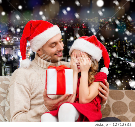 smiling daughter waiting for present from father smiling daughter waiting for present from father 12712332