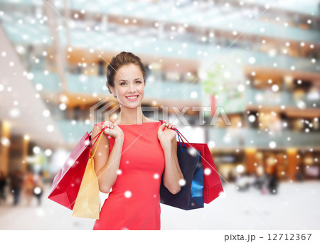 smiling woman with colorful shopping bags 12712367