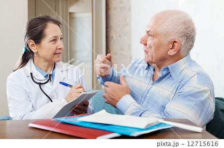 Sick senior man complaining to doctor about malaise 12715616