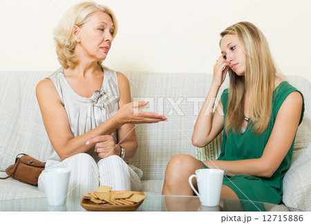 Young woman and mature mother having serious talking Young woman and mature mother having serious talking 12715886