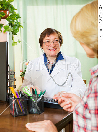 Mature doctor consulting female patient Mature doctor consulting female patient 12716207