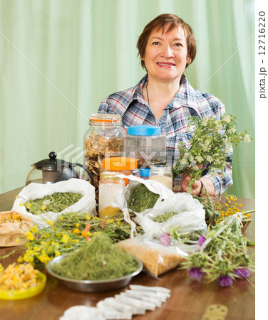 elderly woman with medicinal herbs elderly woman with medicinal herbs 12716220