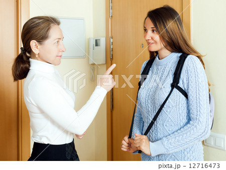 Mature woman say parting words his young daughter 12716473