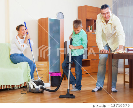 Ordinary family doing house cleaning 12716579