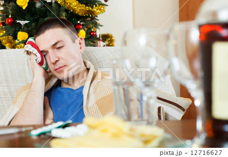 Guy having hangover after celebrating New year Guy having hangover after celebrating New year 12716627
