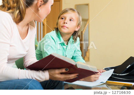 Mother with son doing homework 12716630