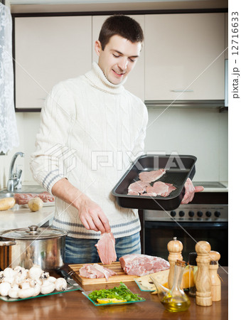 man cooking meat man cooking meat 12716633