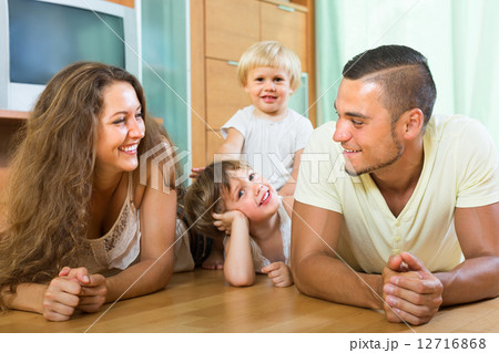 Happy family of four at home Happy family of four at home 12716868