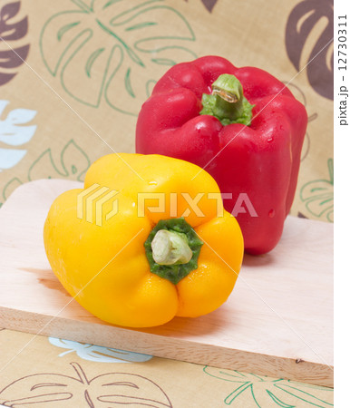 Bell Peppers on a Wooden Cutting Board. Bell Peppers on a Wooden Cutting Board. 12730311